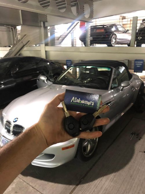 BMW with keys being held up to the outside of the car | Alohomora Locksmith Services All BMW Makes and Models in Portland OR