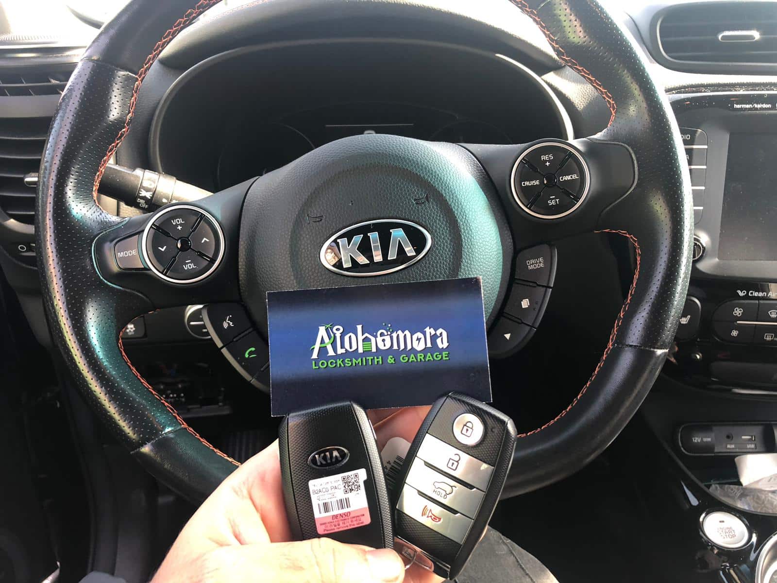 Inside a BMW with keys being held up to the steering wheel | Alohomora Locksmith Services All BMW Makes and Models in Portland OR