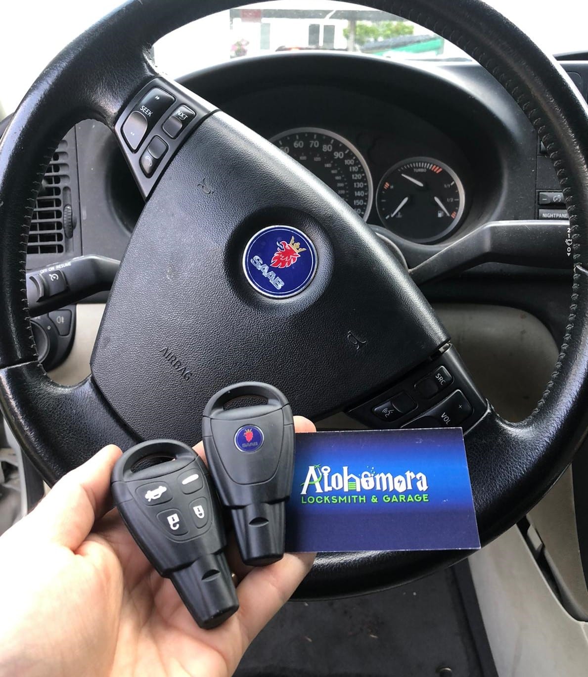 BMW with keys being held up to the outside of the car | Alohomora Locksmith Services All BMW Makes and Models in Portland OR